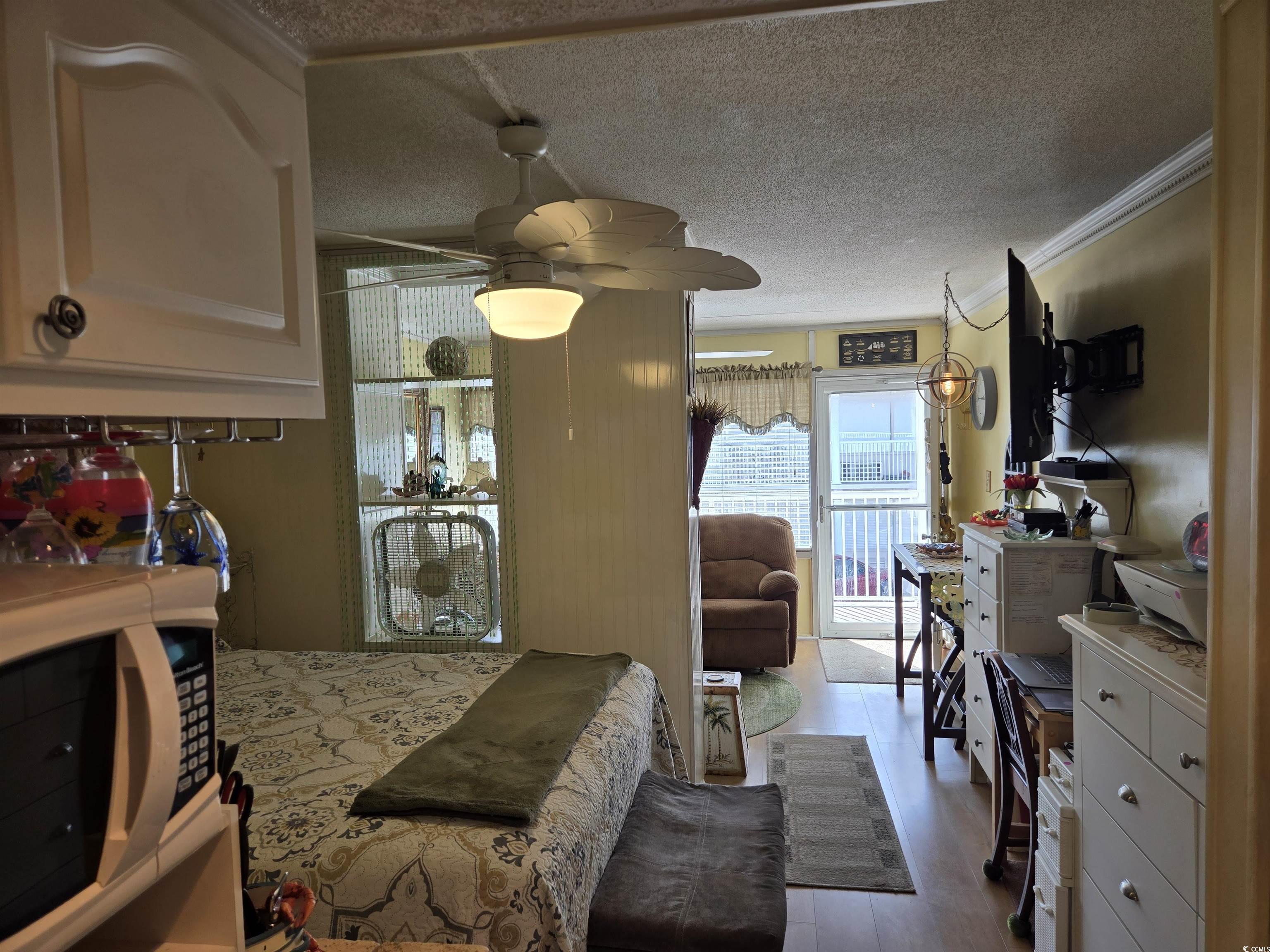 2204 Perrin Drive, Unit 3 North Myrtle Beach, SC 29582 - Photo 26 of 39 Dining room with ceiling fan, ornamental molding, a textured ceiling, and light hardwood / wood-style flooring