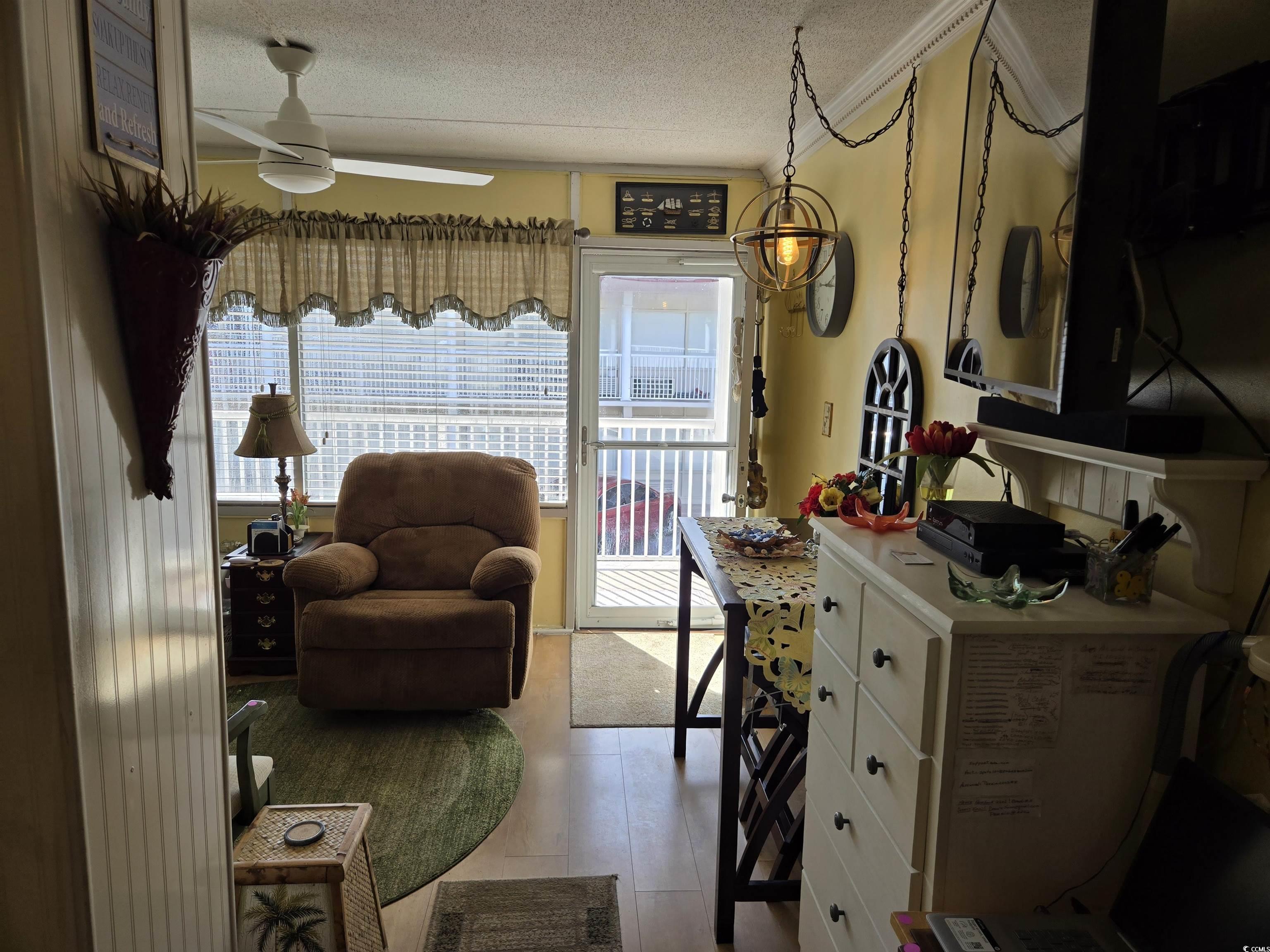 2204 Perrin Drive, Unit 3 North Myrtle Beach, SC 29582 - Photo 27 of 39 Living area with a textured ceiling, ceiling fan, light hardwood / wood-style floors, and plenty of natural light