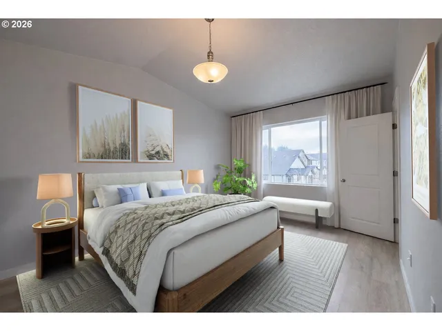 a bedroom with a large bed and a chandelier