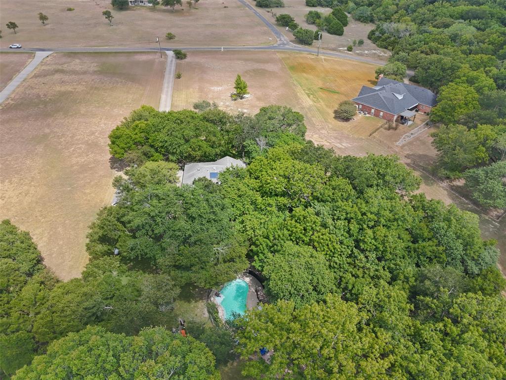 318 Ridge Creek Road Waxahachie, TX 75167 - Photo 40 of 40 Private property with mature trees, a swimming pool, and a gravel driveway