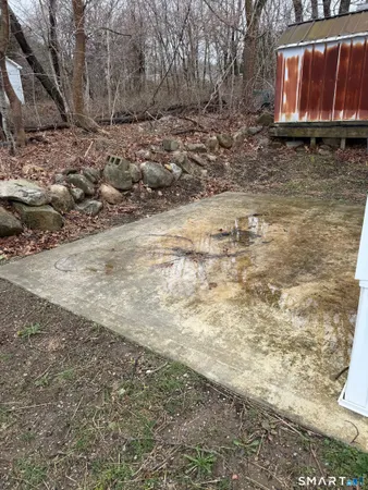 a view of a dry yard with wooden fence