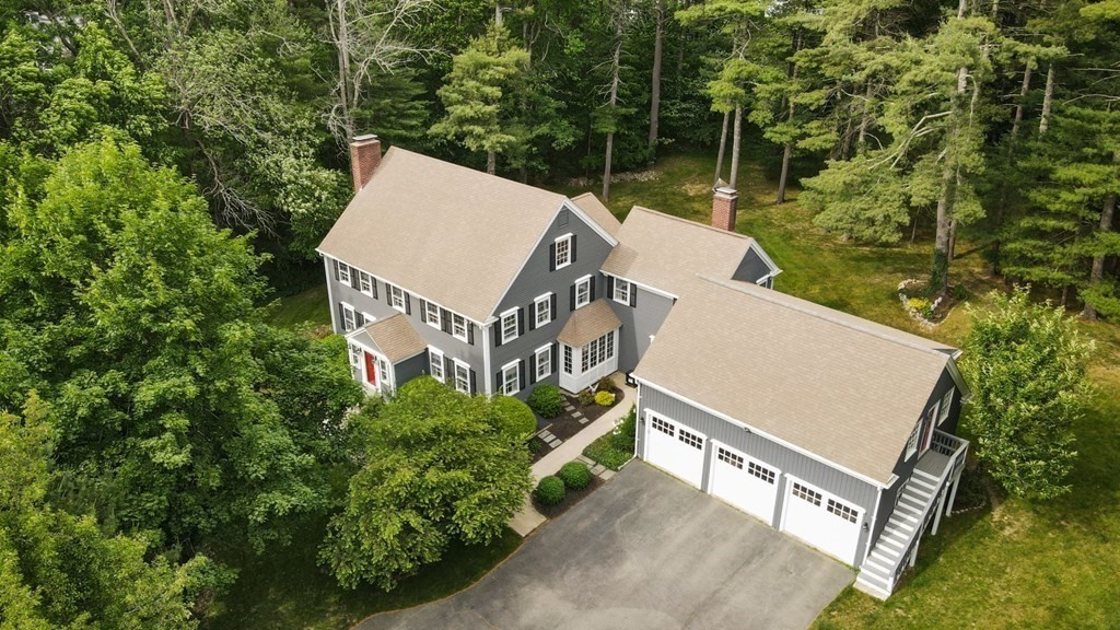 an aerial view of a house with a yard and deck area