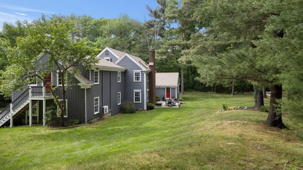 18 Pine Street Dover, MA 02030 - Photo 18 of 20 a backyard of a house with table and chairs