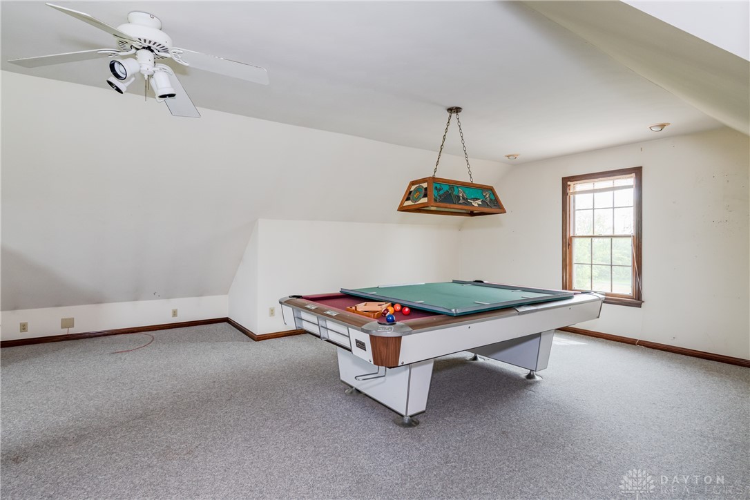 9981 Ridge Acres Lane Englewood, OH 45322 - Photo 41 of 73 This versatile room, perfect for recreation, features soft carpeting and ample natural light.