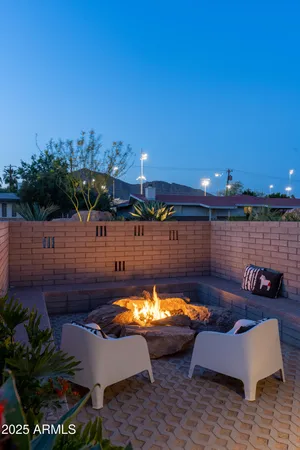 a view of a swimming pool and lounge chairs