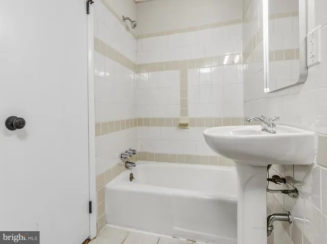 a bathroom with a bathtub and a sink