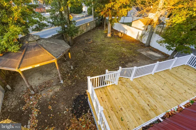 a view of a balcony with wooden floor and fence