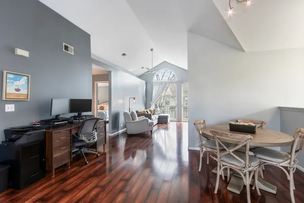 a view of a workspace with furniture and wooden floor