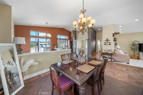 a view of a dining room with furniture and chandelier