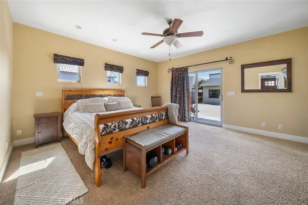 a bedroom with a large bed and a chandelier