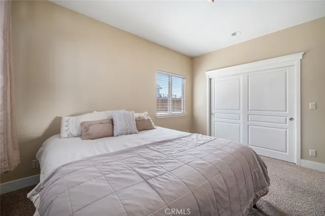 a bedroom with a large bed and a window