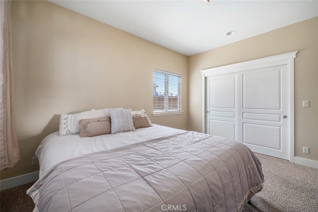 159 Ash Avenue Cayucos, CA 93430 - Photo 26 of 44 a bedroom with a bed and closet