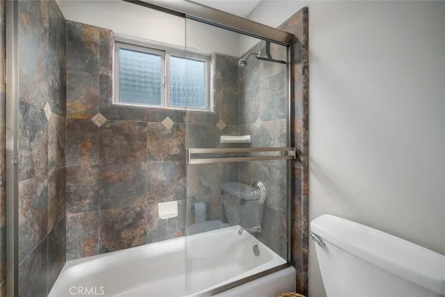 a bedroom with a bed and a flat tv screen