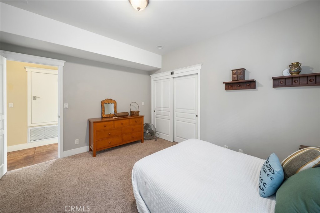 159 Ash Avenue Cayucos, CA 93430 - Photo 32 of 44 a bedroom with a bed and a window