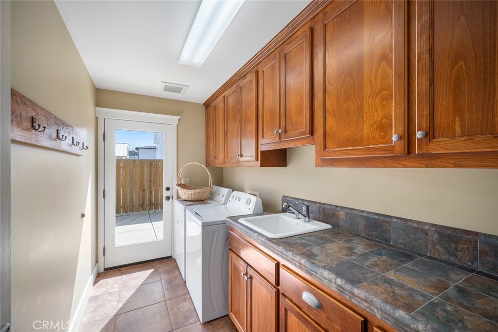 159 Ash Avenue Cayucos, CA 93430 - Photo 36 of 44 a kitchen with stainless steel appliances granite countertop wooden cabinets a sink and dishwasher