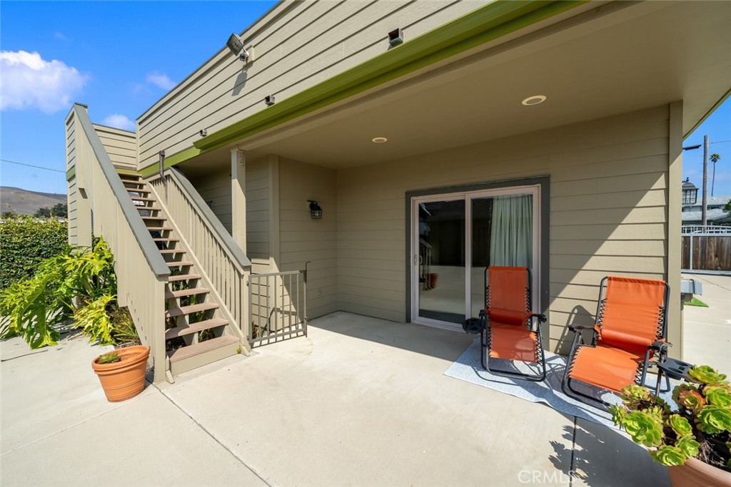 159 Ash Avenue Cayucos, CA 93430 - Photo 43 of 44 a balcony with chairs and a potted plant