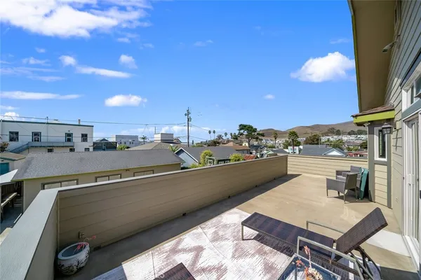 a view of a terrace with furniture and a kitchen