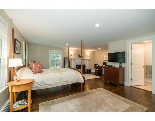 1073 Bay Road Hamilton, MA 01982 - Photo 17 of 36 a bedroom with a bed and a flat screen tv