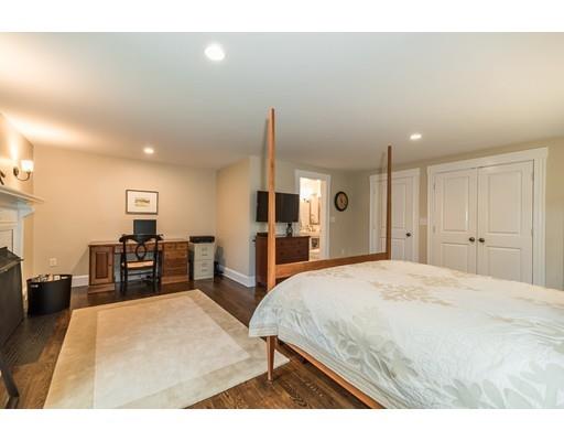 1073 Bay Road Hamilton, MA 01982 - Photo 18 of 36 a spacious bedroom with a bed and a flat screen tv