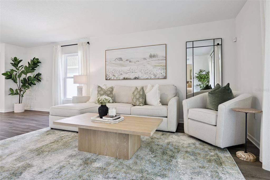 4257 Fennec Fox Way Lakeland, FL 33810 - Photo 11 of 29 a living room with furniture and a potted plant