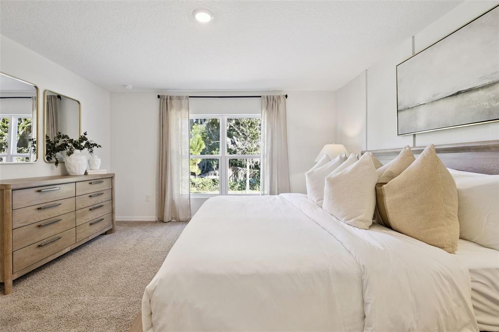 4257 Fennec Fox Way Lakeland, FL 33810 - Photo 17 of 29 a bedroom with a bed and a dresser