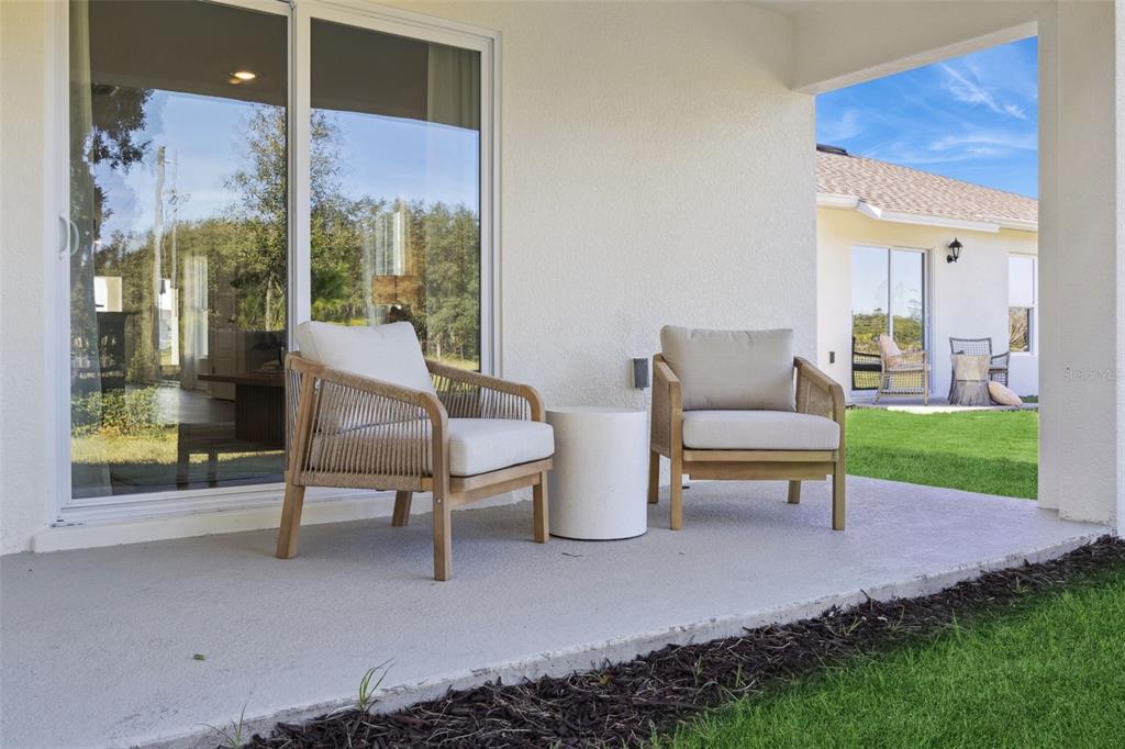 4257 Fennec Fox Way Lakeland, FL 33810 - Photo 29 of 29 a view of a patio with a table chairs and a backyard