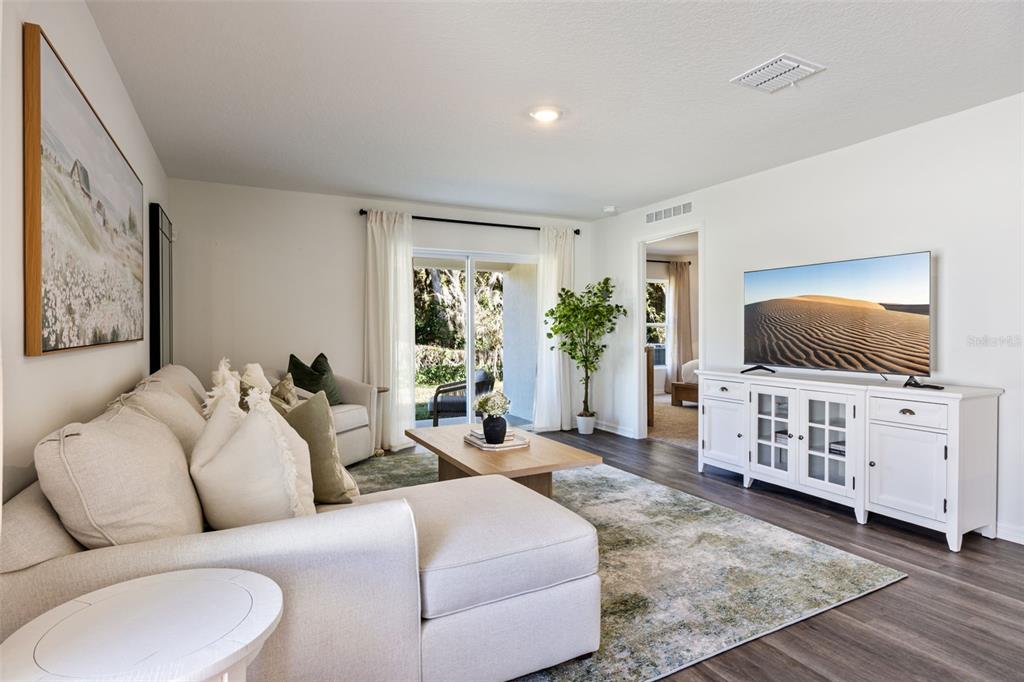 4257 Fennec Fox Way Lakeland, FL 33810 - Photo 8 of 29 a living room with furniture and a flat screen tv