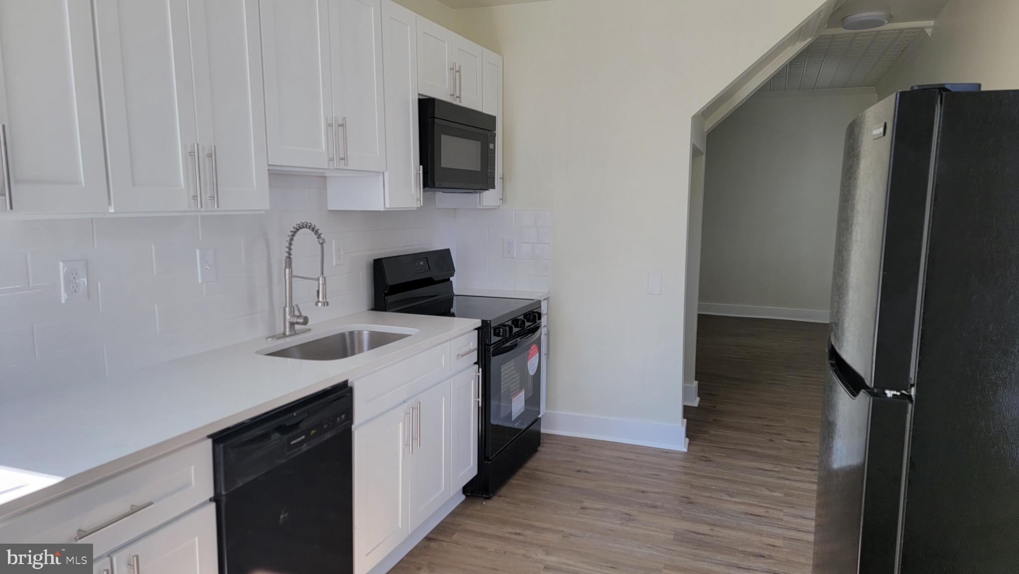 637 South Paca Street, Unit B Baltimore, MD 21230 - Photo 2 of 5 Modern kitchen with sleek white cabinetry.