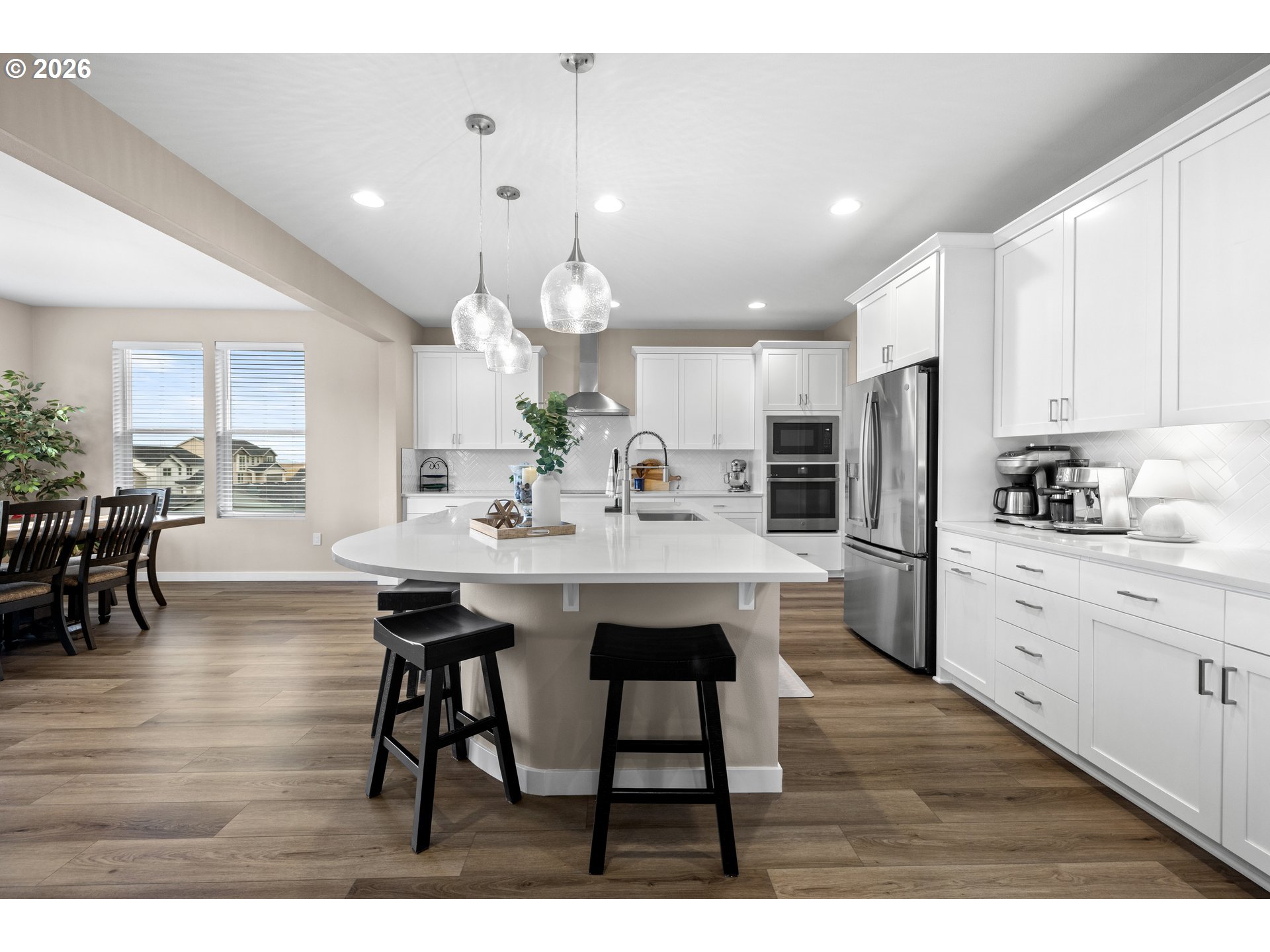 2081 Northeast Ridge Run Lane Estacada, OR 97023 - Photo 14 of 46 a kitchen with stainless steel appliances kitchen island granite countertop a table chairs sink and cabinets