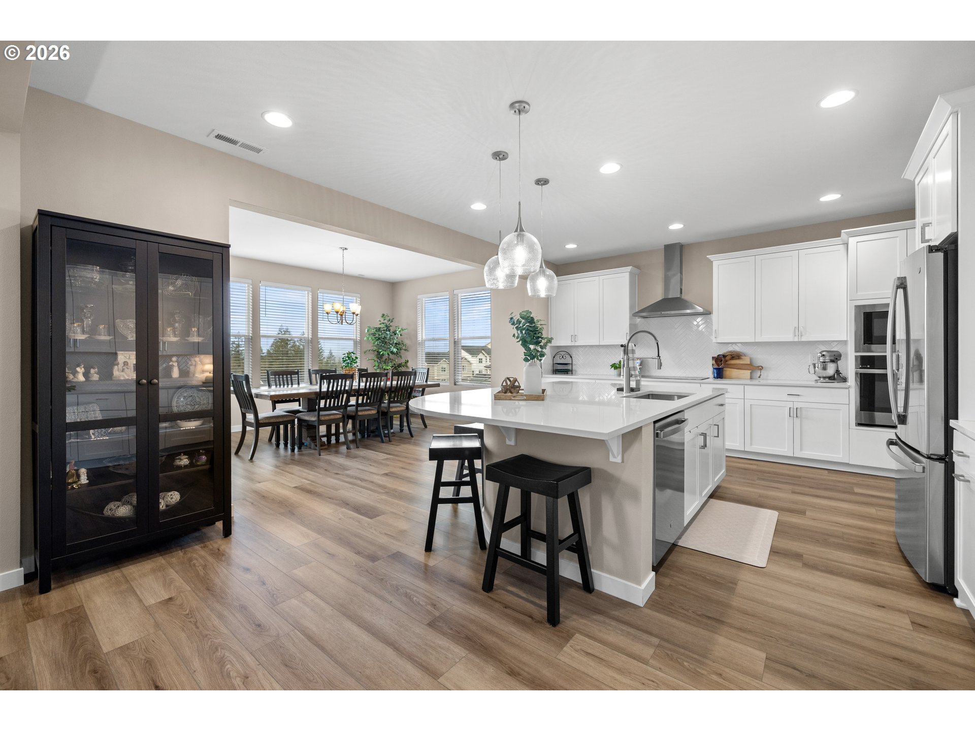 2081 Northeast Ridge Run Lane Estacada, OR 97023 - Photo 15 of 46 a kitchen with stainless steel appliances kitchen island granite countertop a table chairs and a refrigerator