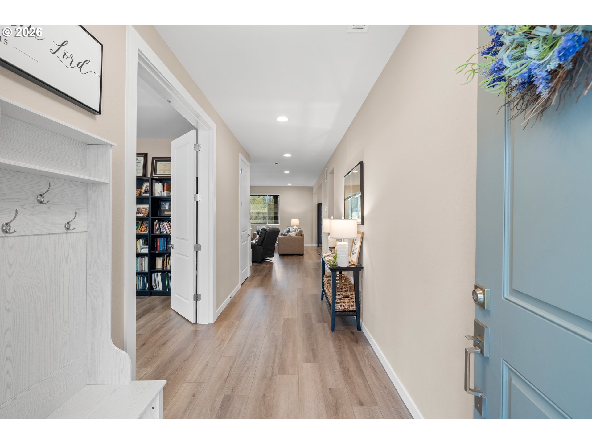 2081 Northeast Ridge Run Lane Estacada, OR 97023 - Photo 5 of 46 a hallway with wooden floor book shelf and living room