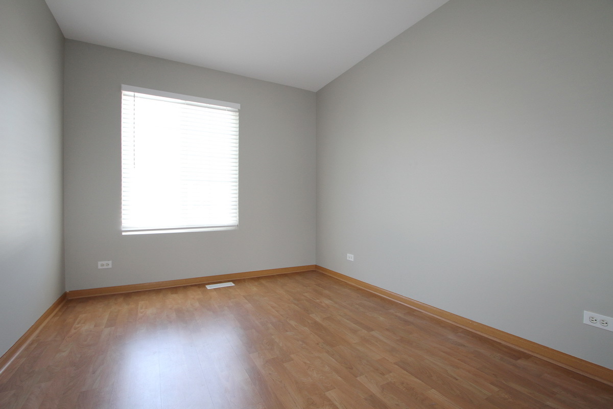 3159 Cambria Court Aurora, IL 60503 - Photo 12 of 20 an empty room with wooden floor and windows