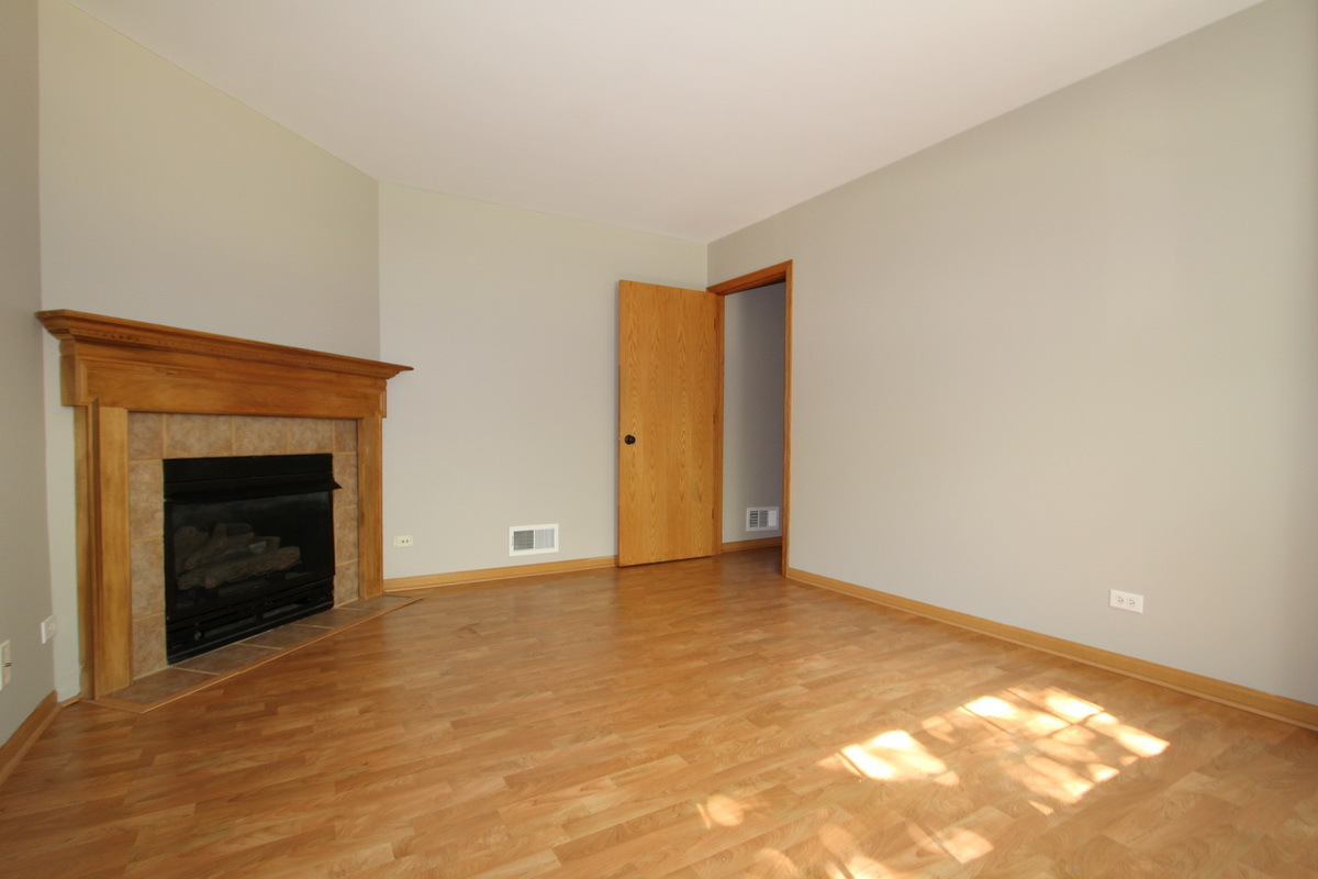 3159 Cambria Court Aurora, IL 60503 - Photo 19 of 20 a view of an empty room with a fireplace