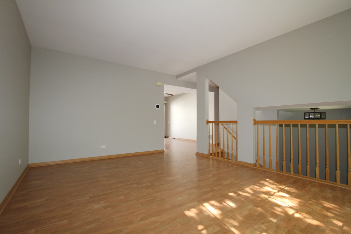 3159 Cambria Court Aurora, IL 60503 - Photo 2 of 20 a view of an empty room with stairs