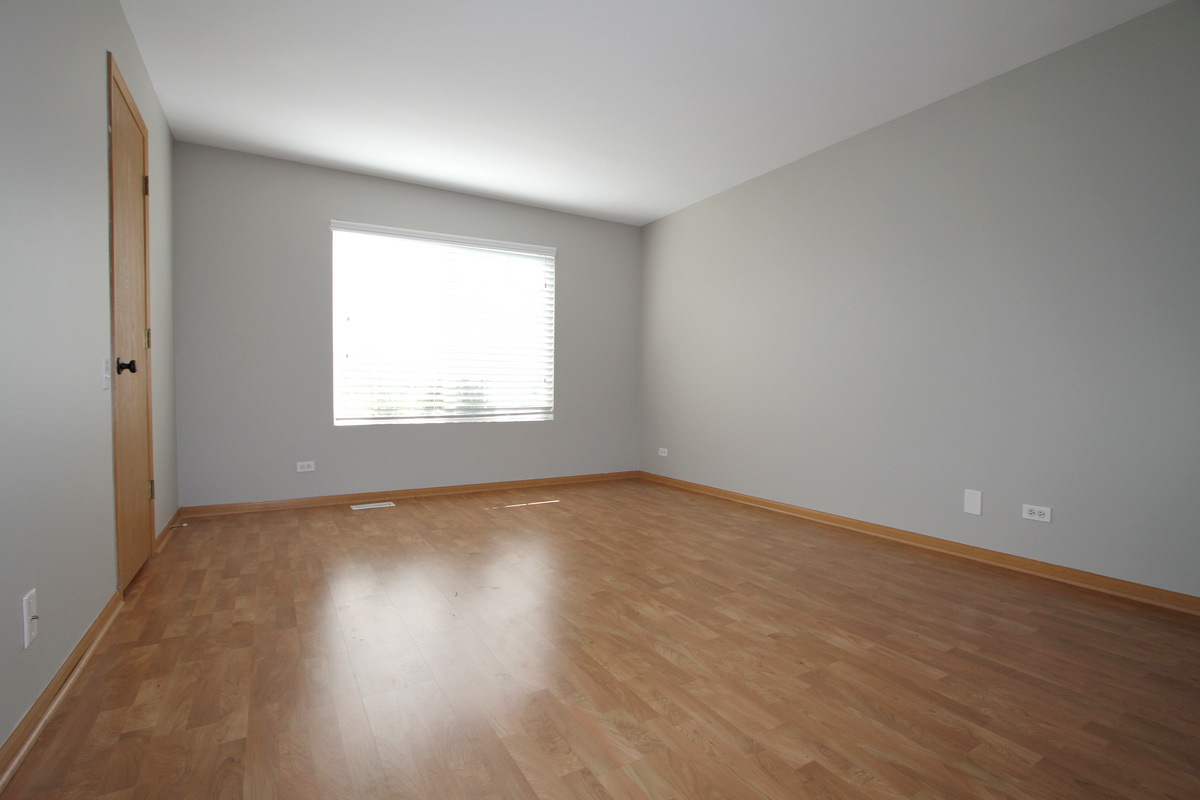 3159 Cambria Court Aurora, IL 60503 - Photo 9 of 20 an empty room with wooden floor and windows