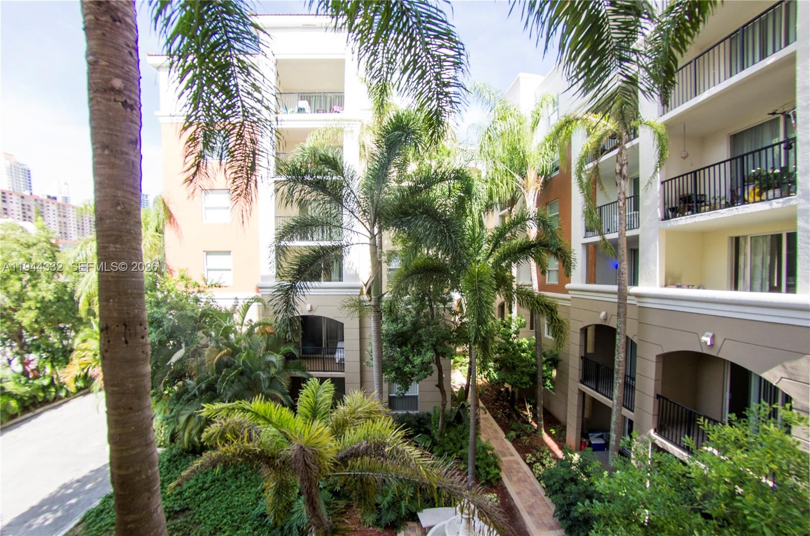 17145 North Bay Road, Unit 4312 Sunny Isles Beach, FL 33160 - Photo 12 of 33 a front view of a multi story building with yard