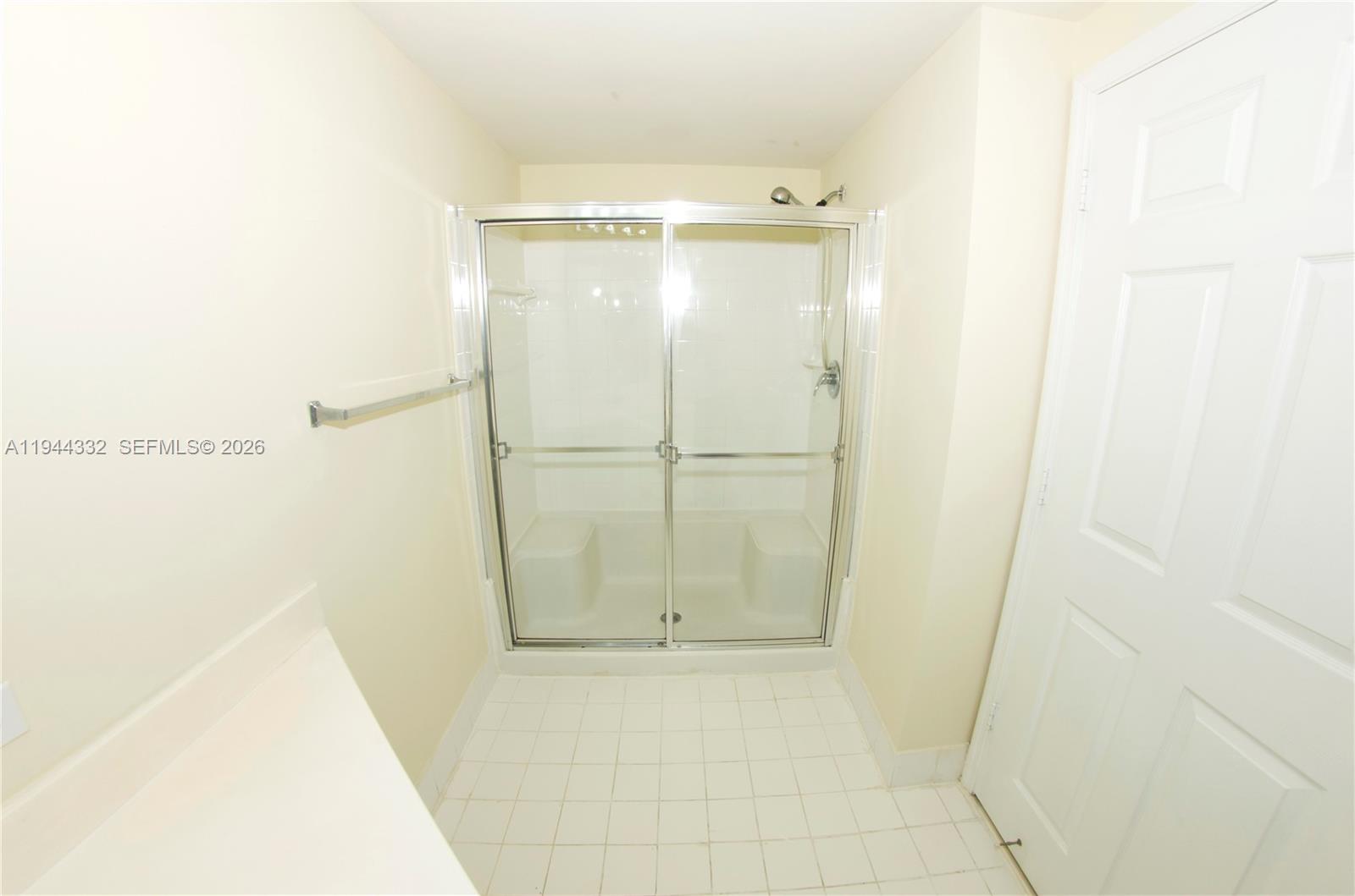 17145 North Bay Road, Unit 4312 Sunny Isles Beach, FL 33160 - Photo 5 of 33 a bathroom with a glass shower door