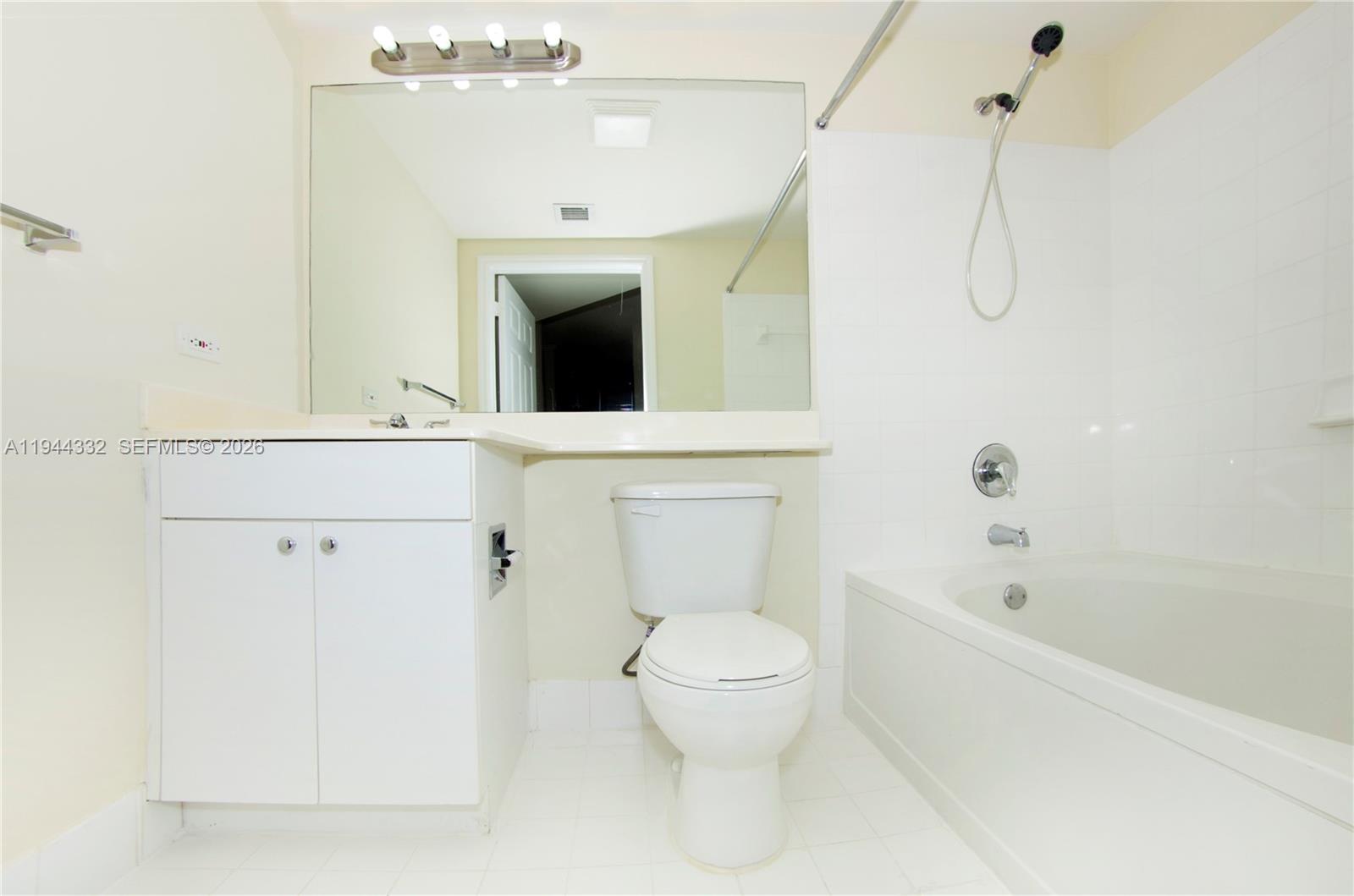 17145 North Bay Road, Unit 4312 Sunny Isles Beach, FL 33160 - Photo 7 of 33 a bathroom with a toilet a sink a mirror and shower