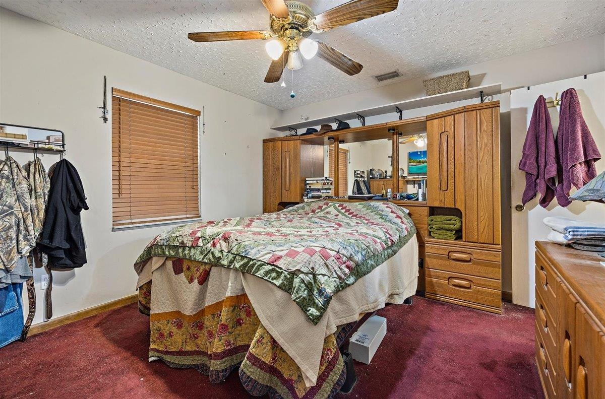120 Pompano Road St. Augustine, FL 32086 - Photo 6 of 18 a bedroom with a bed and a walk in closet