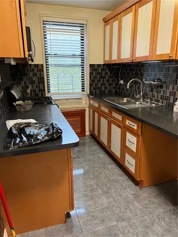 a kitchen with stainless steel appliances granite countertop a sink stove and a refrigerator