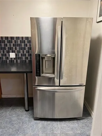 a view of a refrigerator in kitchen