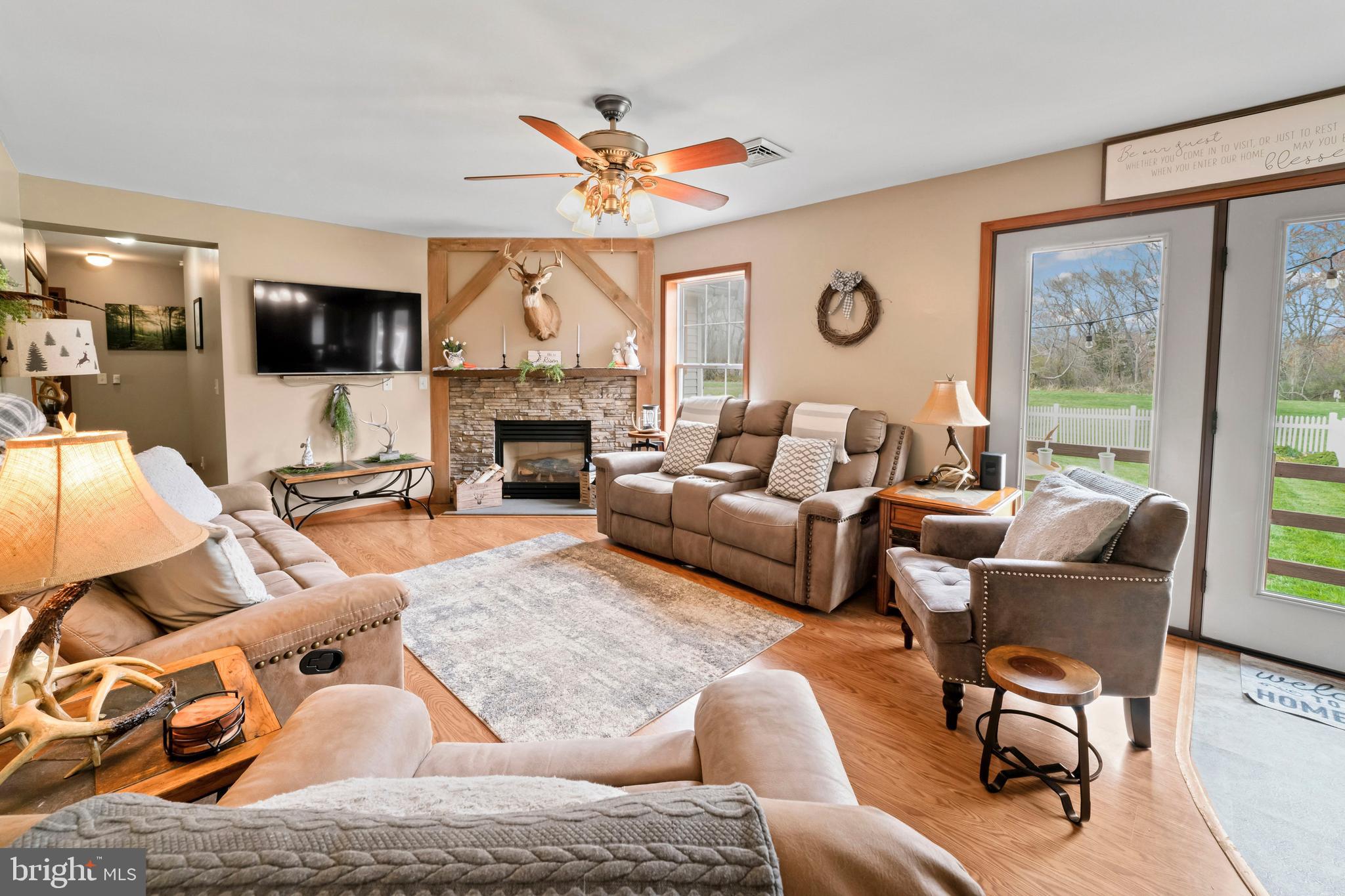 143 County Home Road Pilesgrove, NJ 08098 - Photo 23 of 51 a living room with furniture a fireplace and a flat screen tv