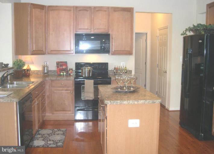 96 Glenbrook Road Ranson, WV 25438 - Photo 3 of 10 a kitchen with stainless steel appliances granite countertop a refrigerator a stove a sink and a microwave