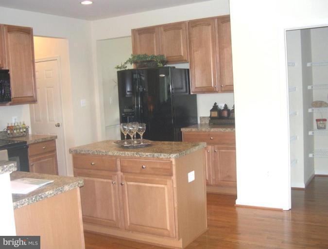 96 Glenbrook Road Ranson, WV 25438 - Photo 4 of 10 a kitchen with stainless steel appliances granite countertop a sink stove and cabinets