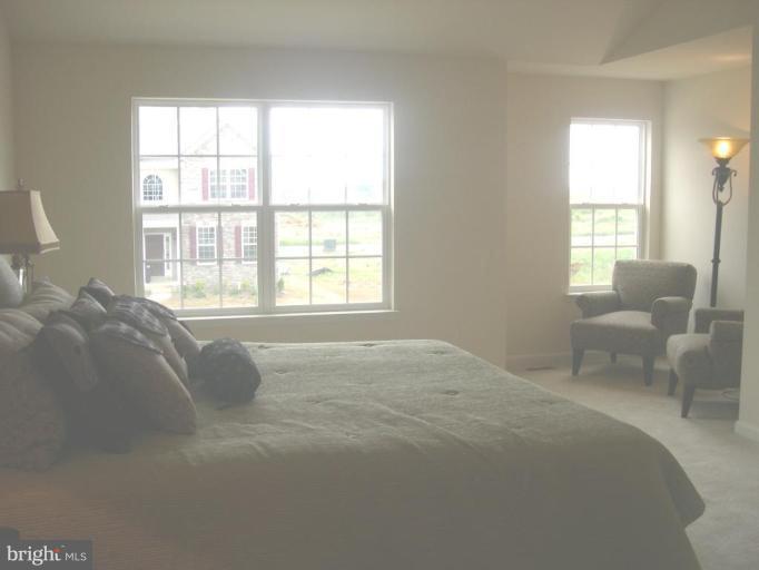 96 Glenbrook Road Ranson, WV 25438 - Photo 9 of 10 a spacious bedroom with a bed and glass window