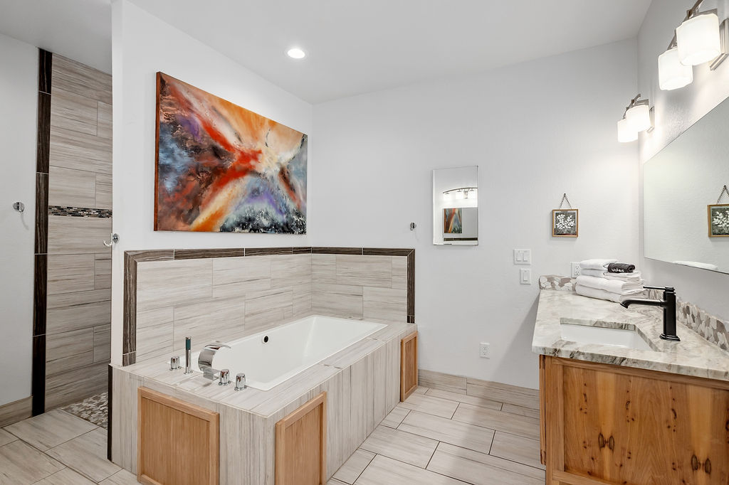13326 Trautwein Road Austin, TX 78737 - Photo 19 of 38 Bathroom featuring a garden tub and double vanity