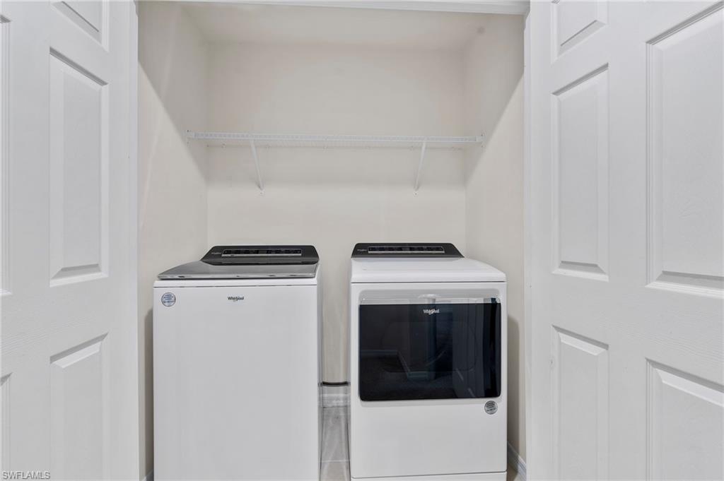 15535 Wildflower Circle Naples, FL 34119 - Photo 19 of 33 a utility room with dryer and washer