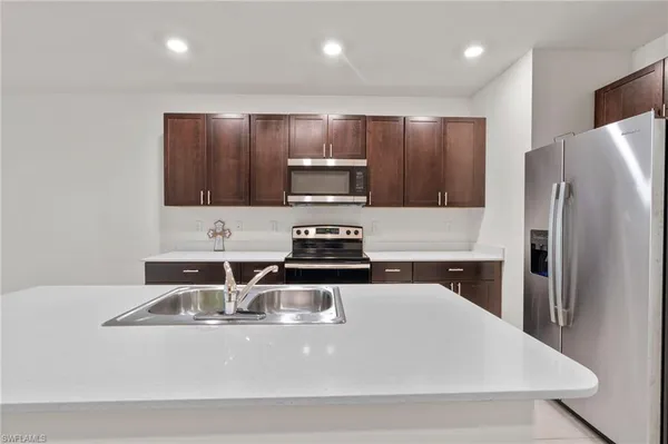 a kitchen with a sink stove and cabinets