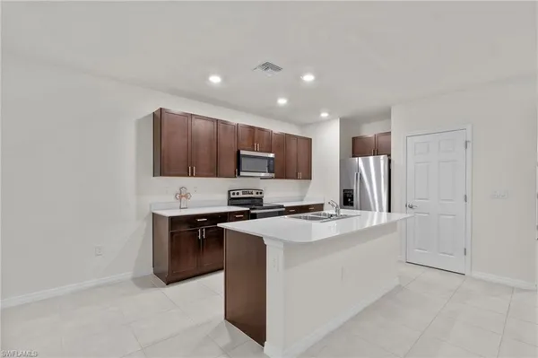 a kitchen with a sink stove and microwave