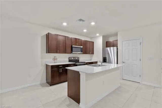 a kitchen with a sink stove and microwave